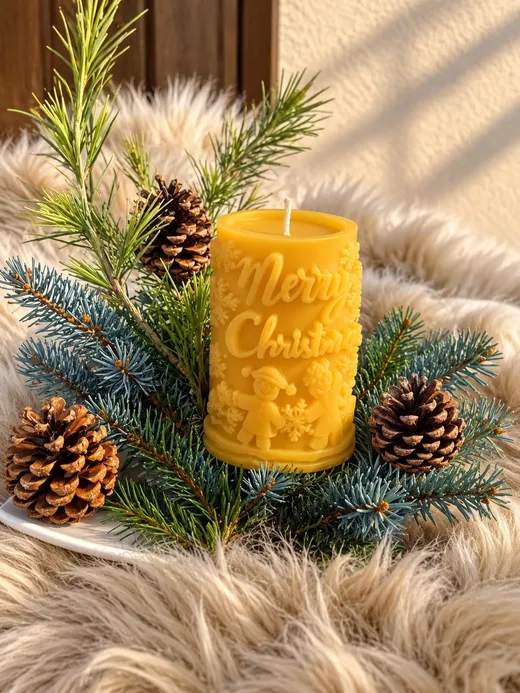 Cylindrical beeswax candle with a Merry Christmas inscription among spruce branches